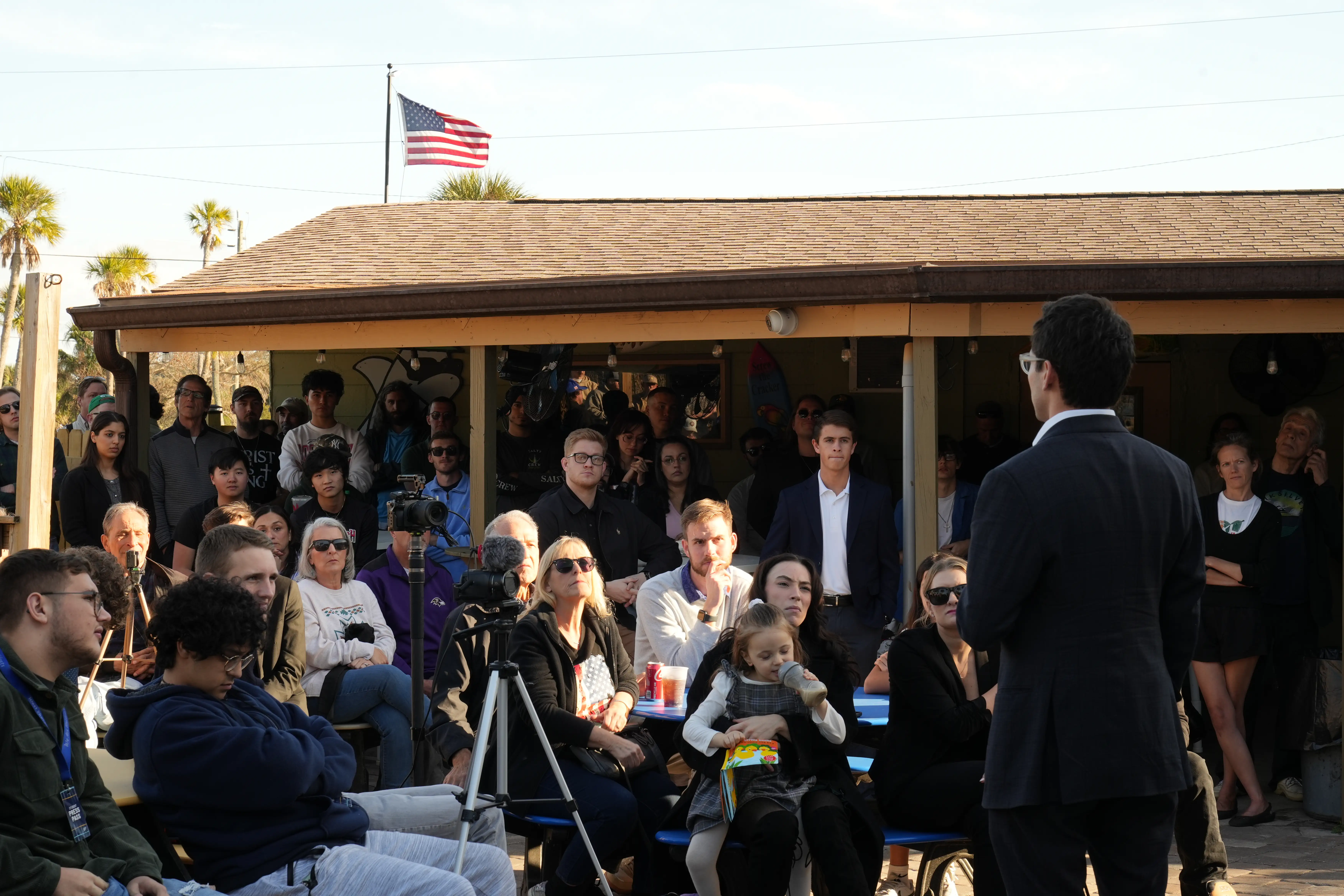 A captive audience gathers under the flag to hear the plan for Florida's future.