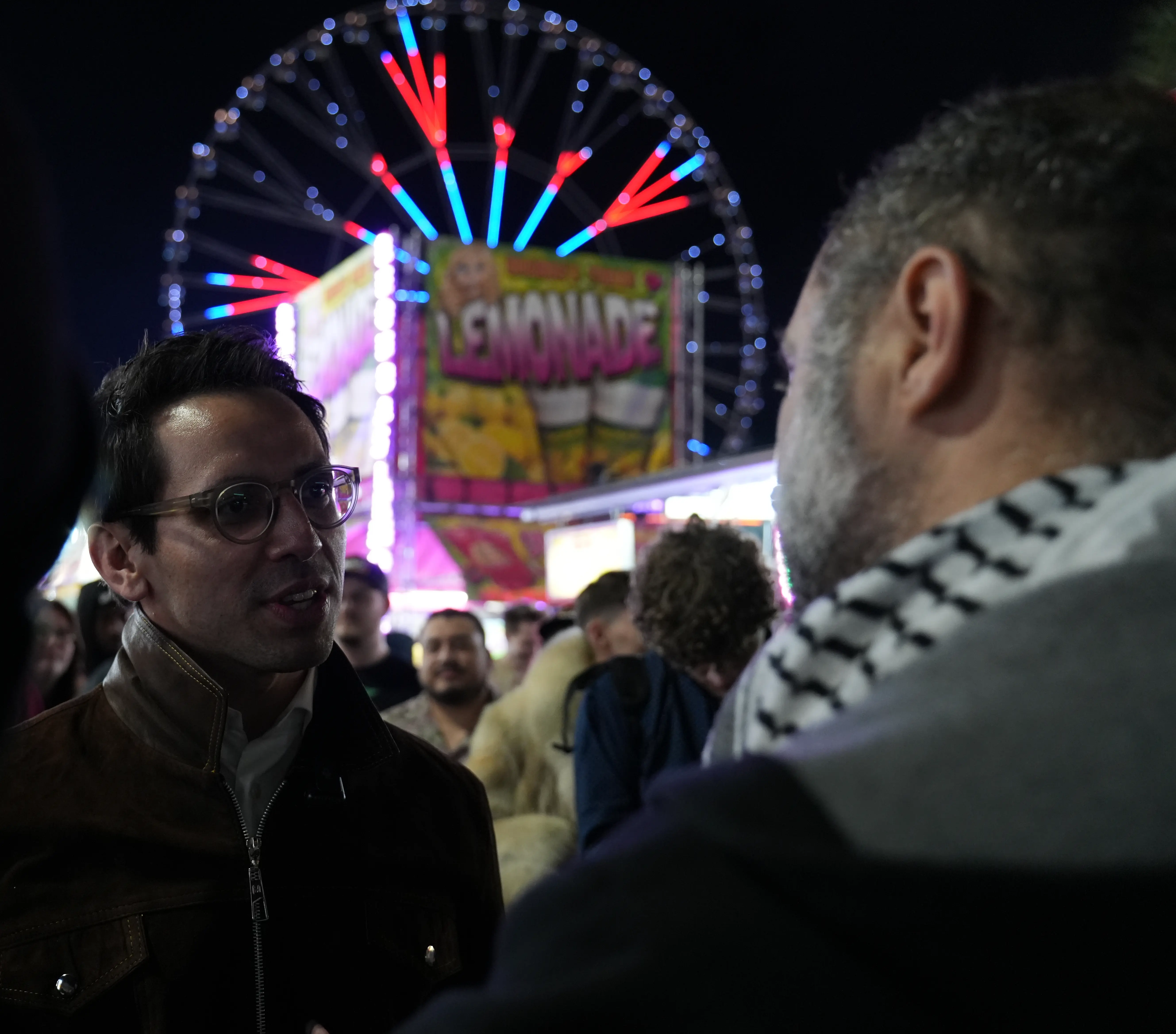 Listening to concerns under the lights of the Ferris wheel.