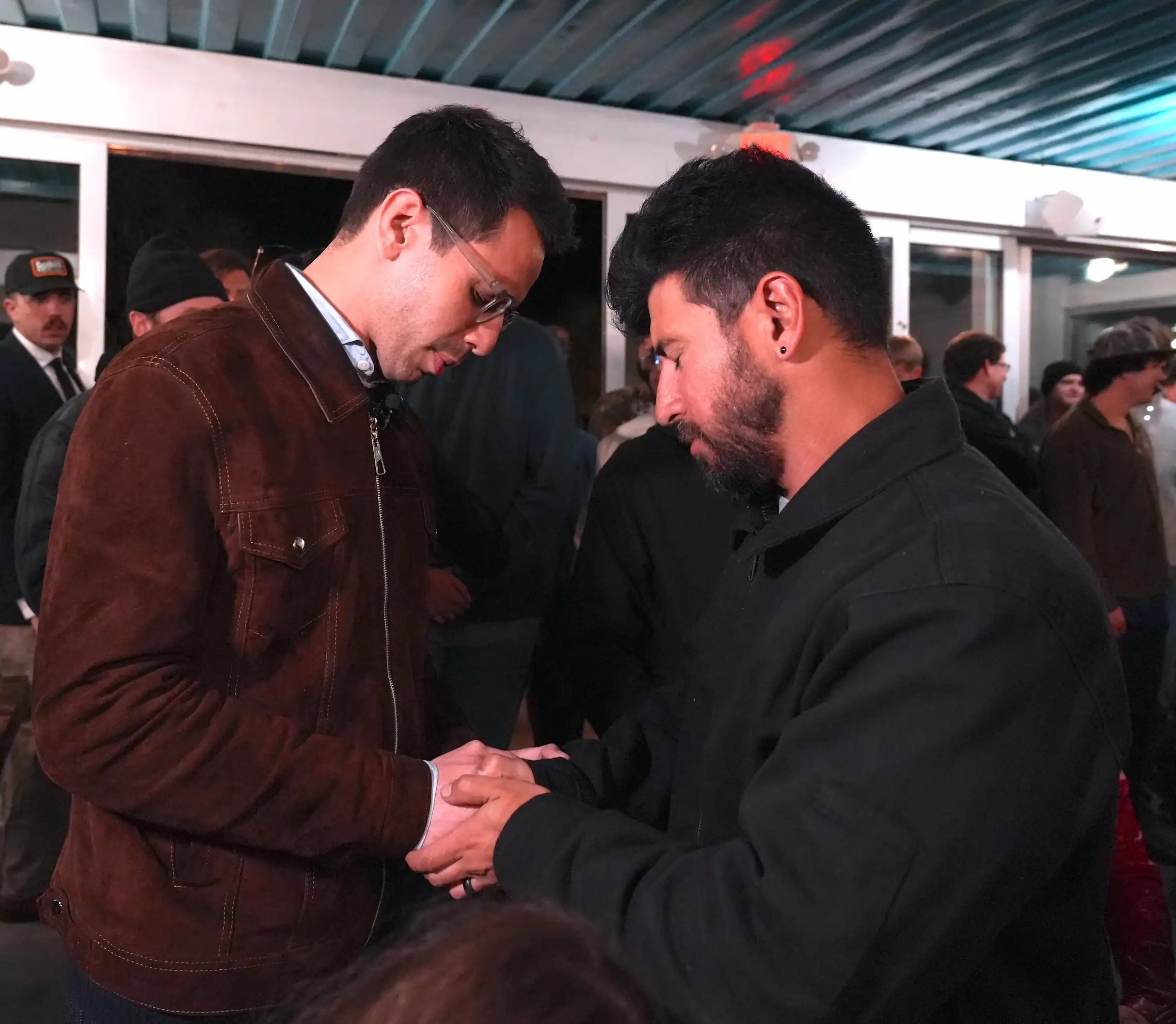 Praying with a local resident.
