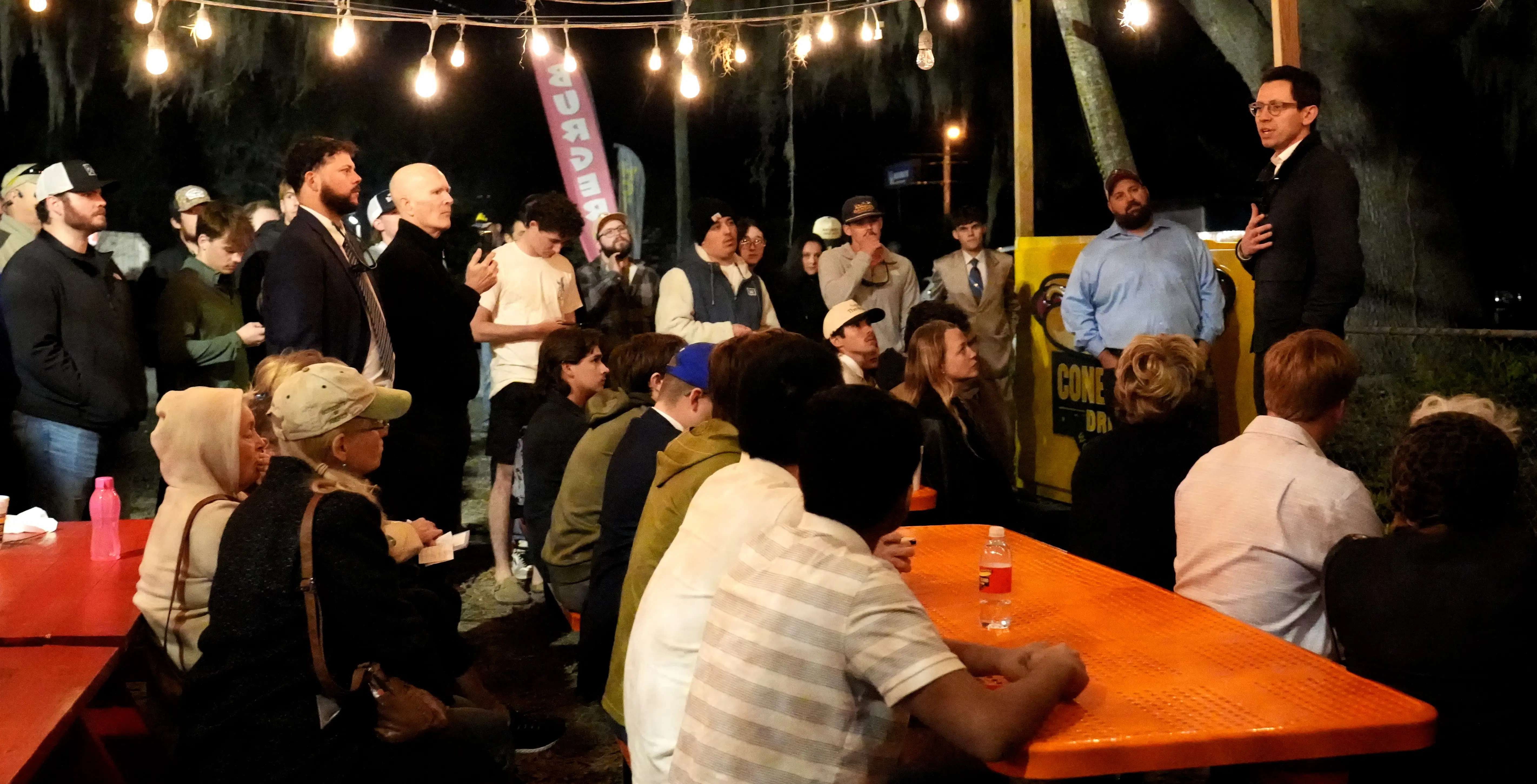 Answering questions from a full turnout of residents