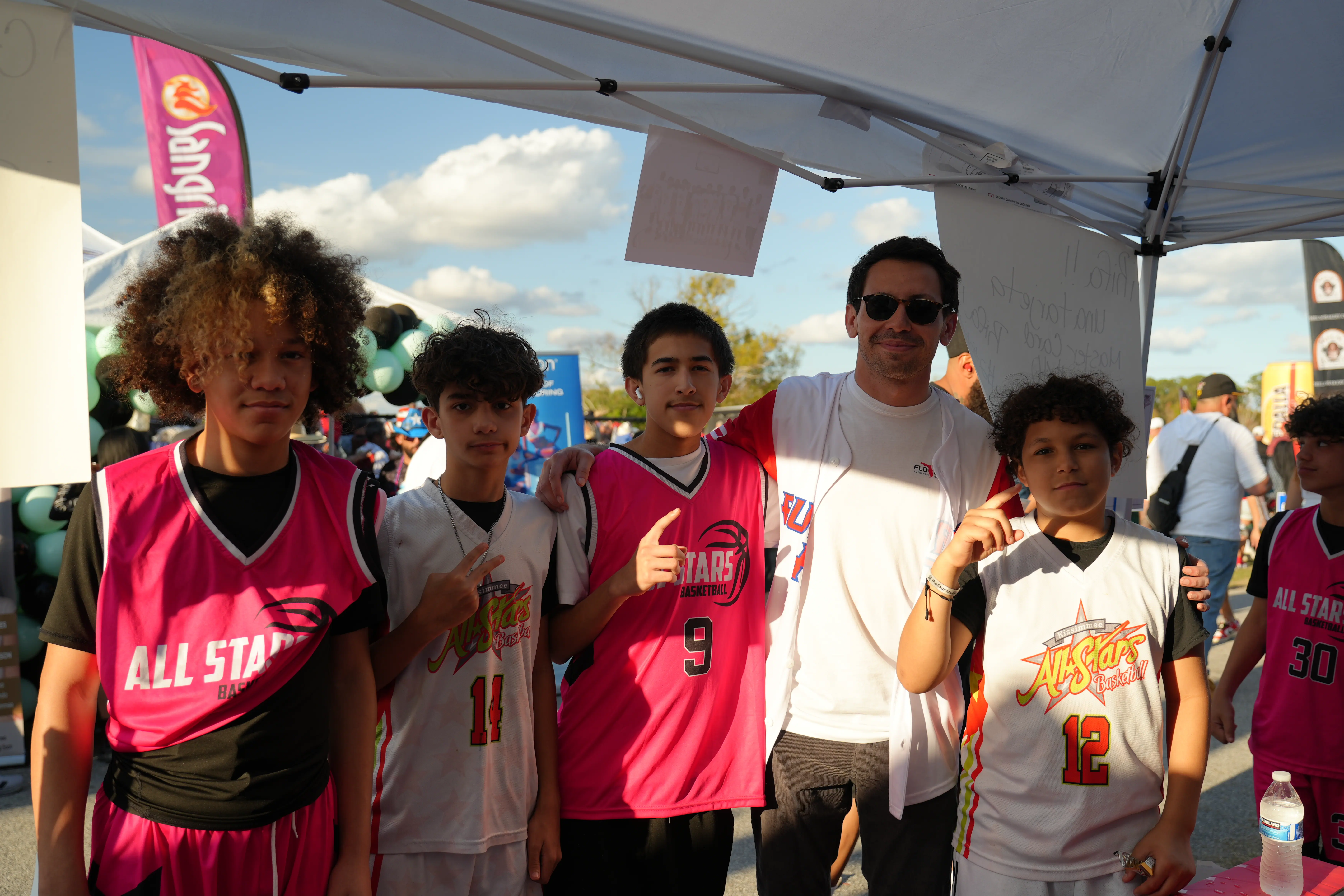 Posing with local youth athletes at the festival.