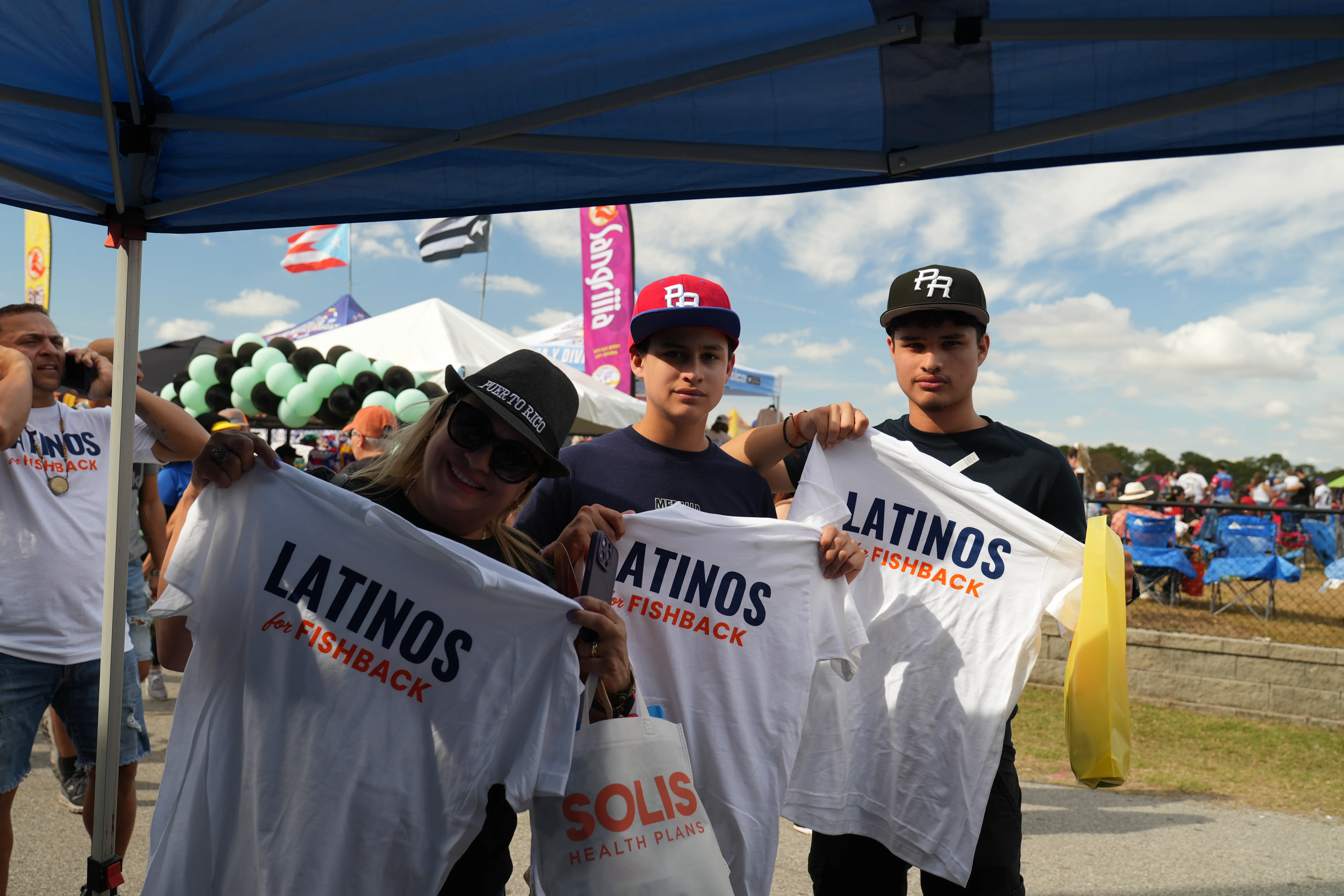 Supporters displaying their "Latinos for Fishback" shirts.